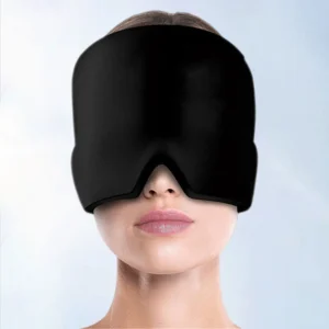 Woman wearing a black cold therapy gel mask for headache and migraine relief, covering the entire forehead and eyes.